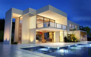 upscale modern luxury home at night with outdoor lighting