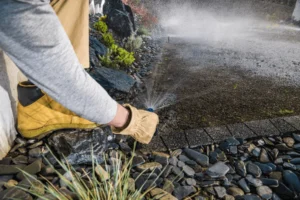A lawn sprinkler repair contractor repairing sprinkler system