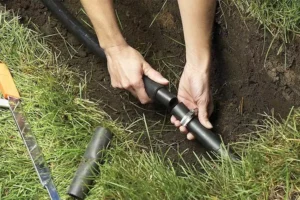 A sprinkler contractor adding sprinkler line with pipe