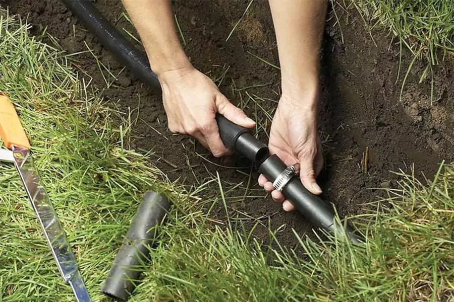 A sprinkler contractor adding sprinkler line with pipe