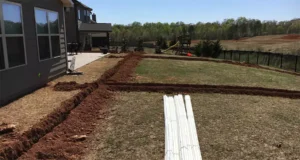 Trenches and irrigation pipes prepared for sprinkler system installation—addressing issues of dry lawns despite regular sprinkler use in Humble, TX.